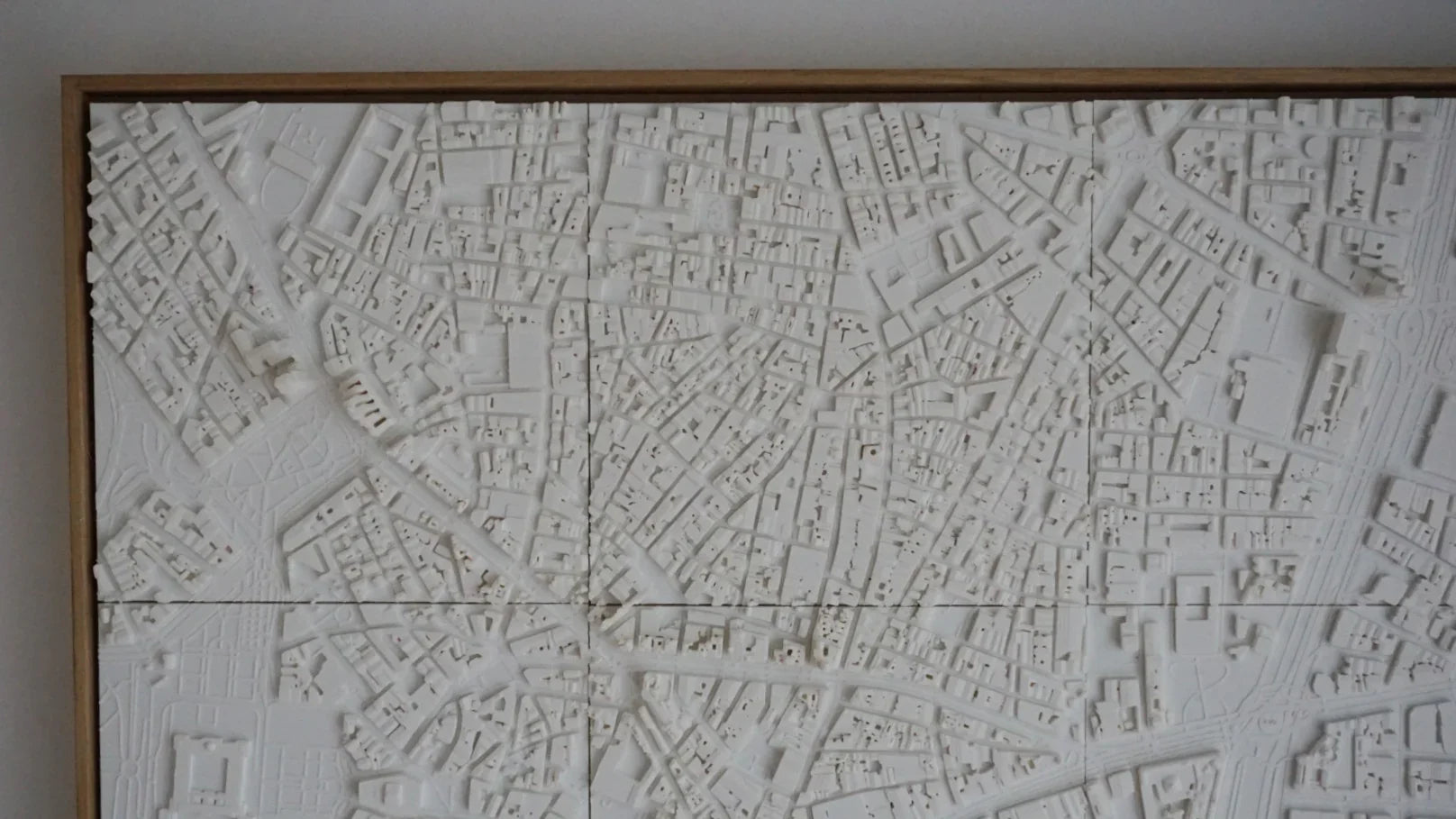 3D city map wall art in white with detailed urban street layout in wooden frame