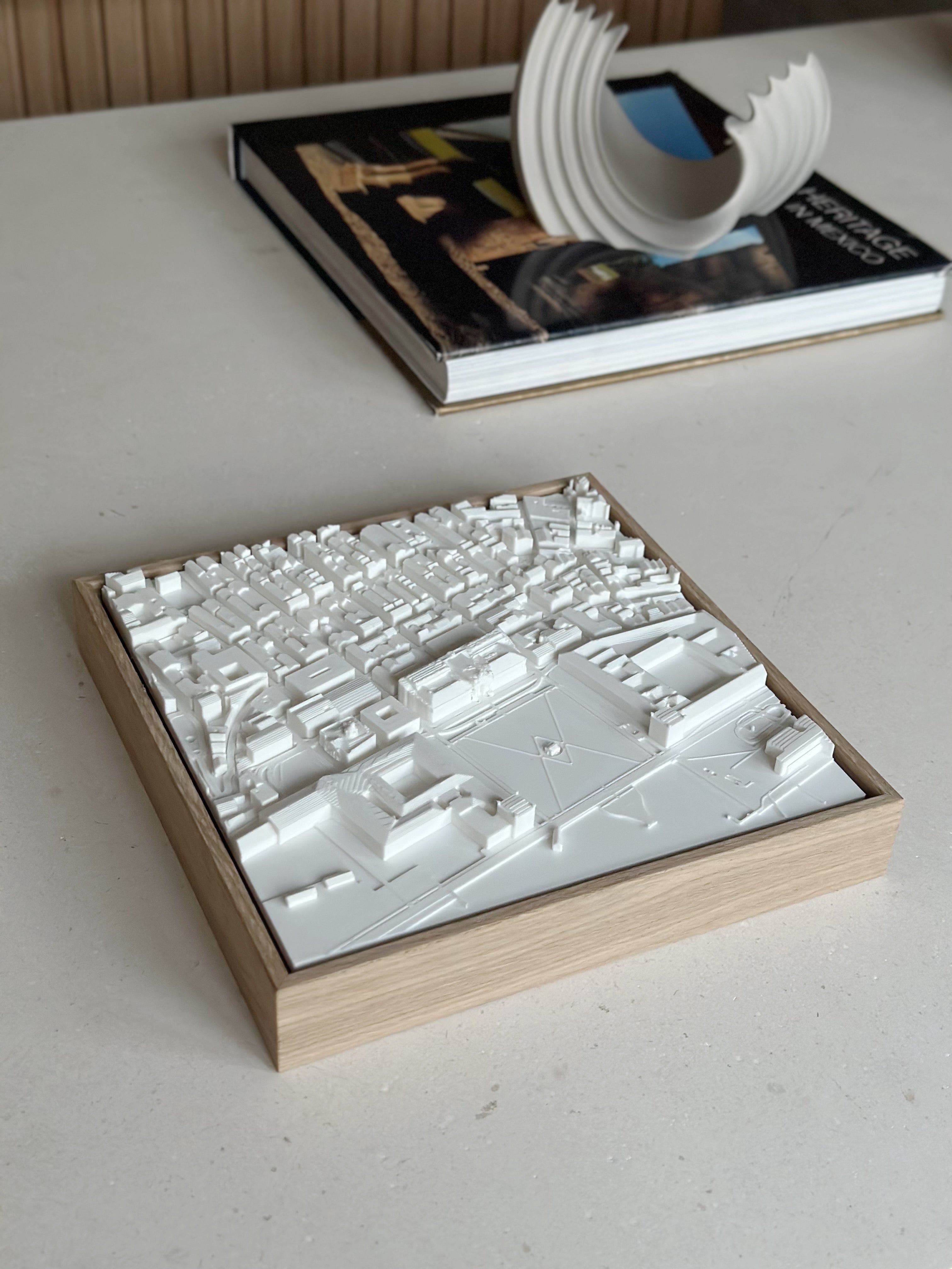 3D city map wall art in wooden frame on table with modern decor and books
