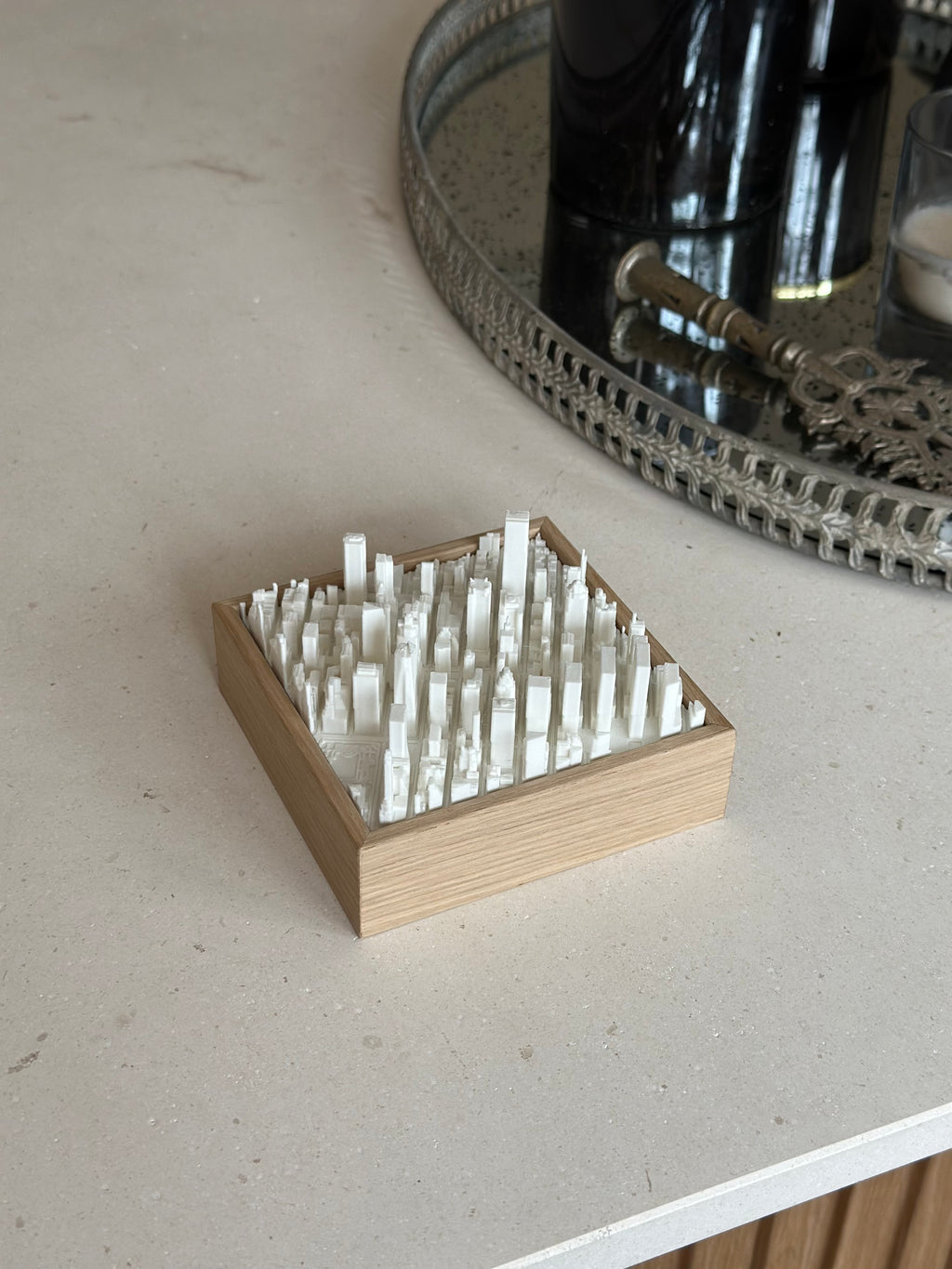 3D city map art with wooden frame on beige tabletop, modern urban decoration