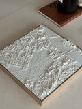 3D city map wall art in white with detailed urban layout on a wooden frame, decorative piece