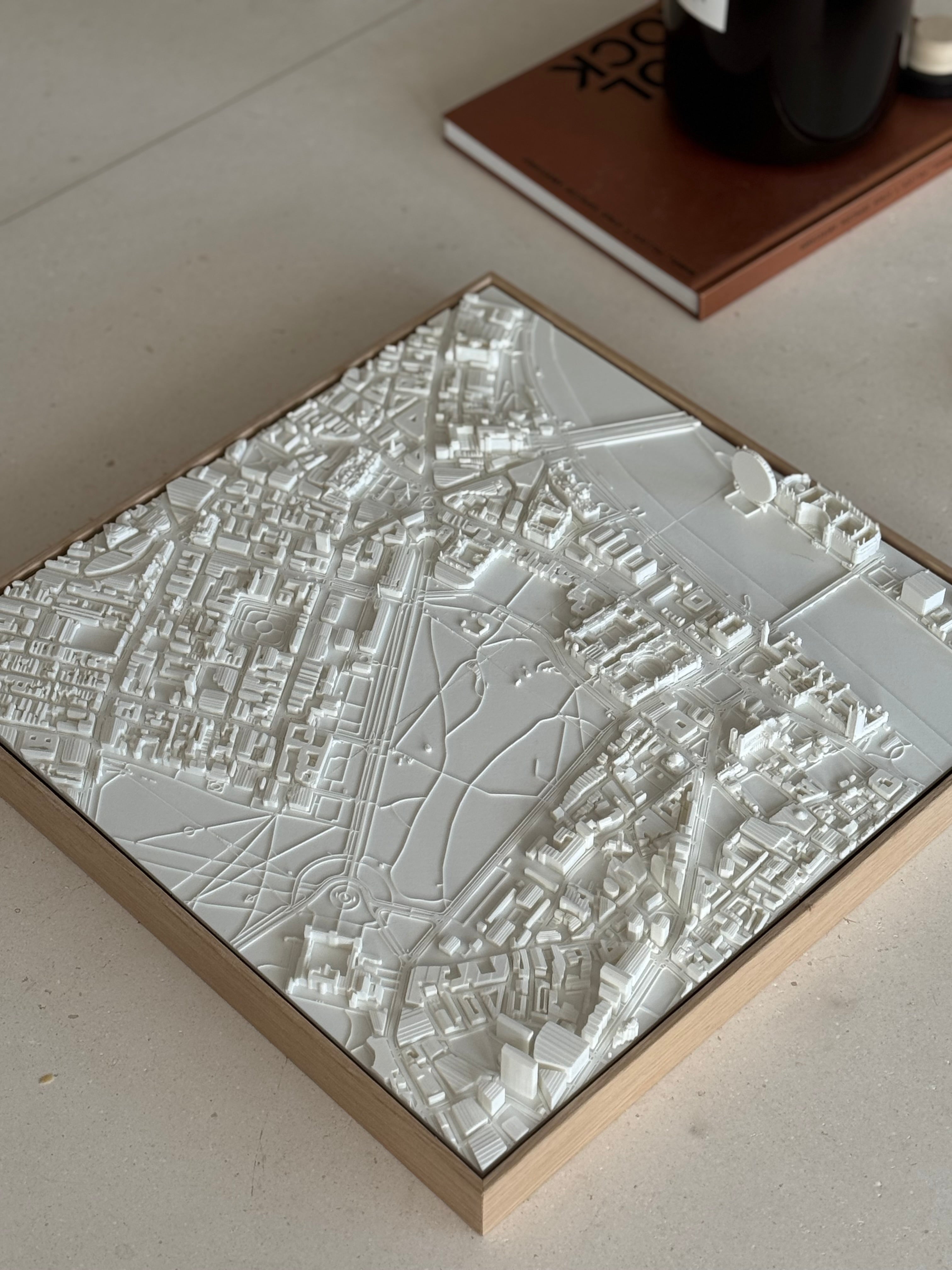 3D city map wall art in white with detailed urban layout on a wooden frame, decorative piece