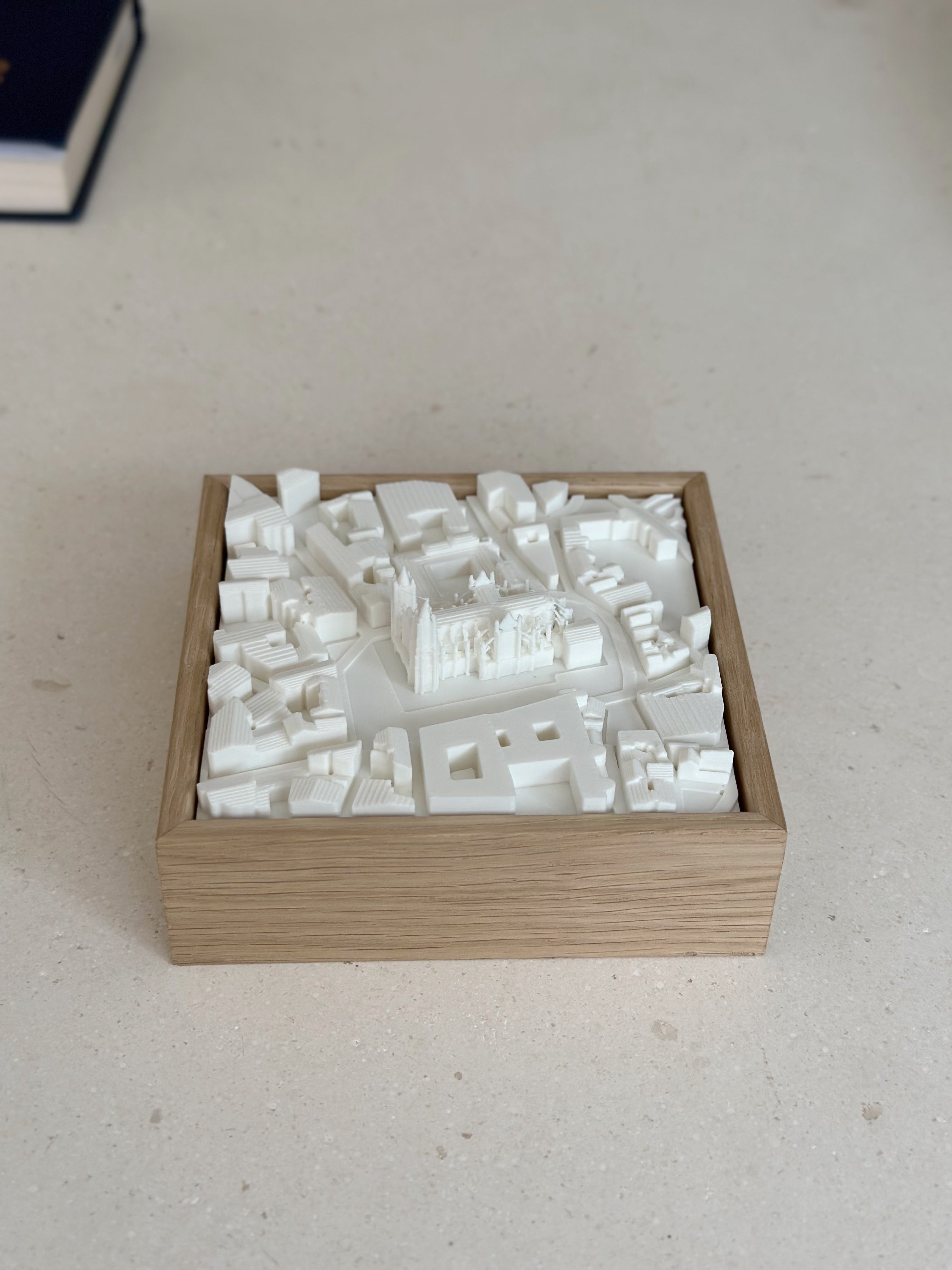 3D city map wall art in a wooden frame, showcasing detailed architectural buildings