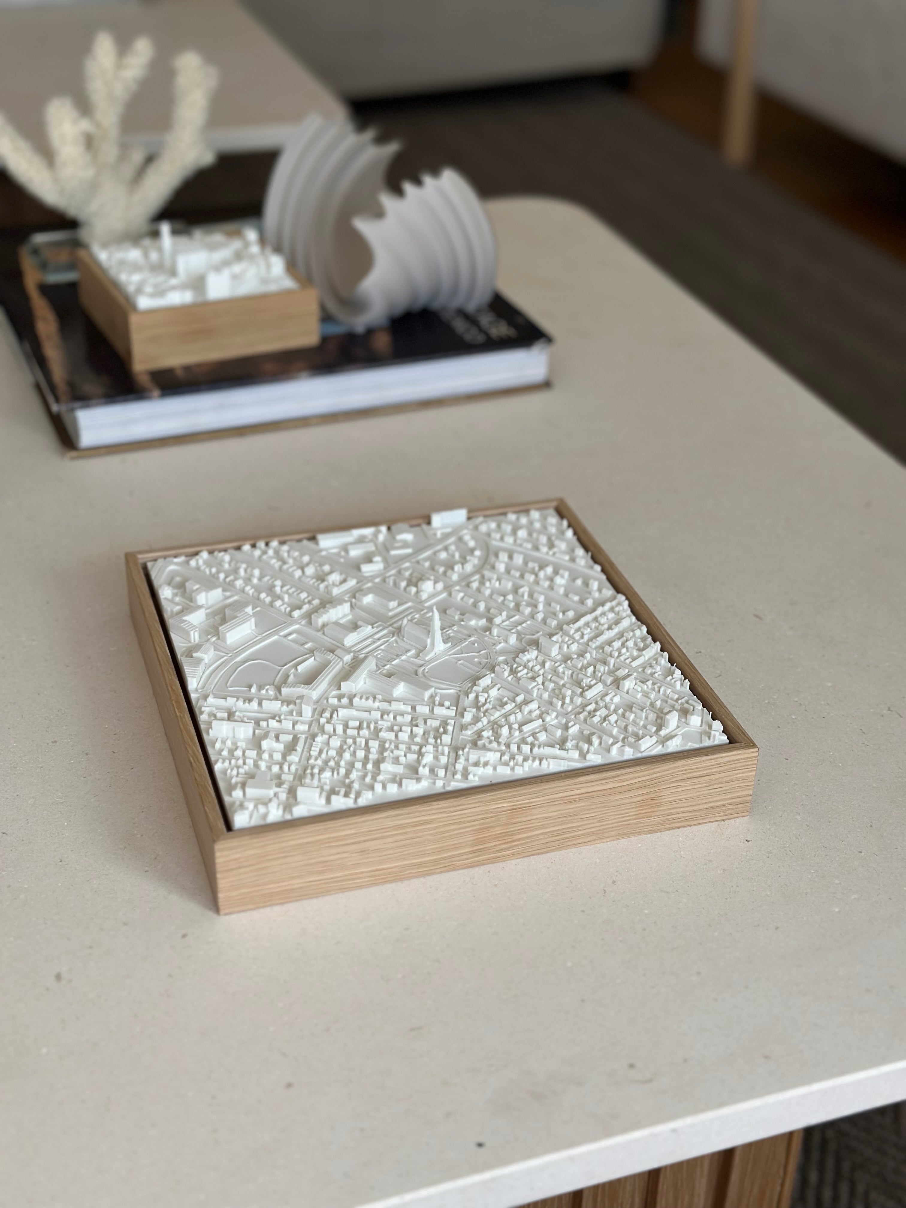 3D city map wall art in wooden frame displayed on a modern coffee table, home decor