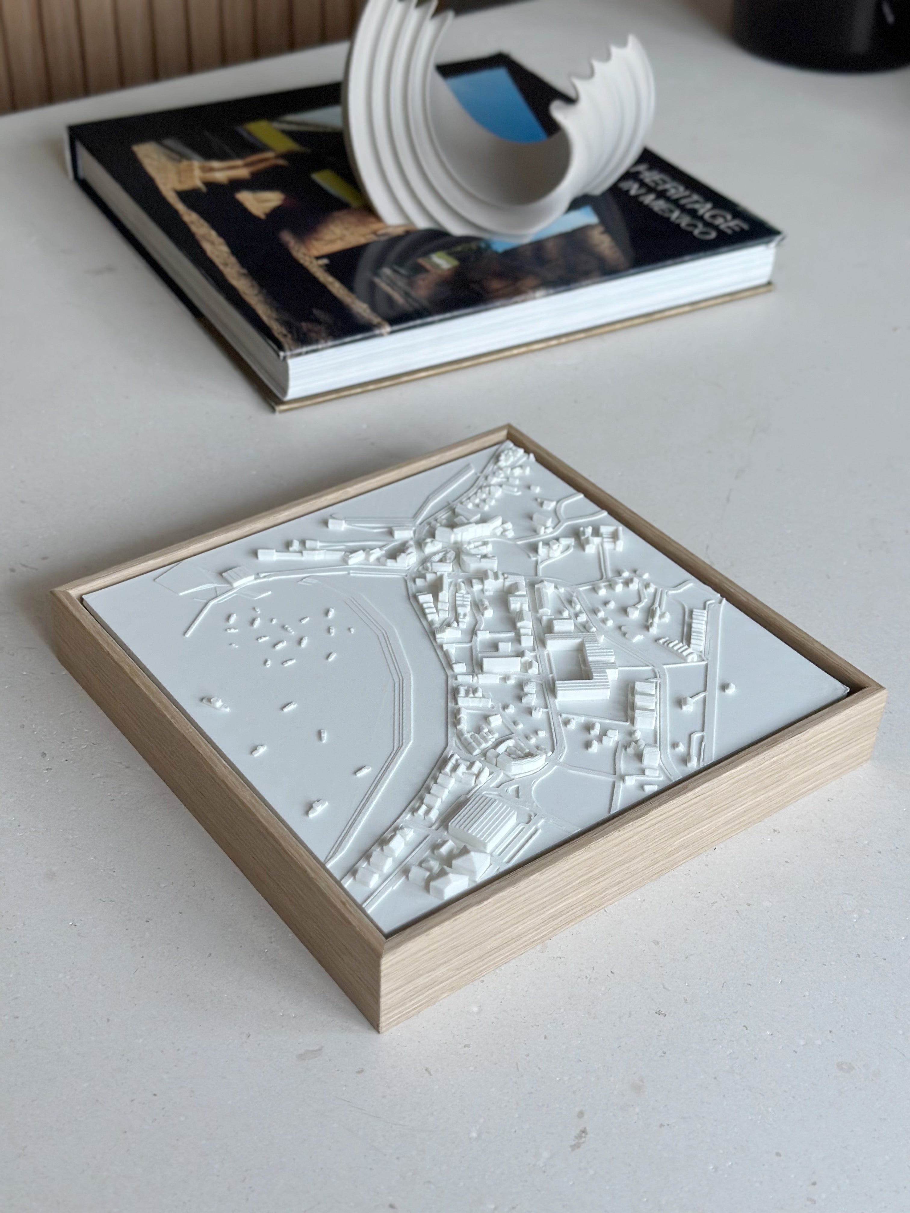 Framed 3D city map artwork on tabletop, minimalist home decor accessory