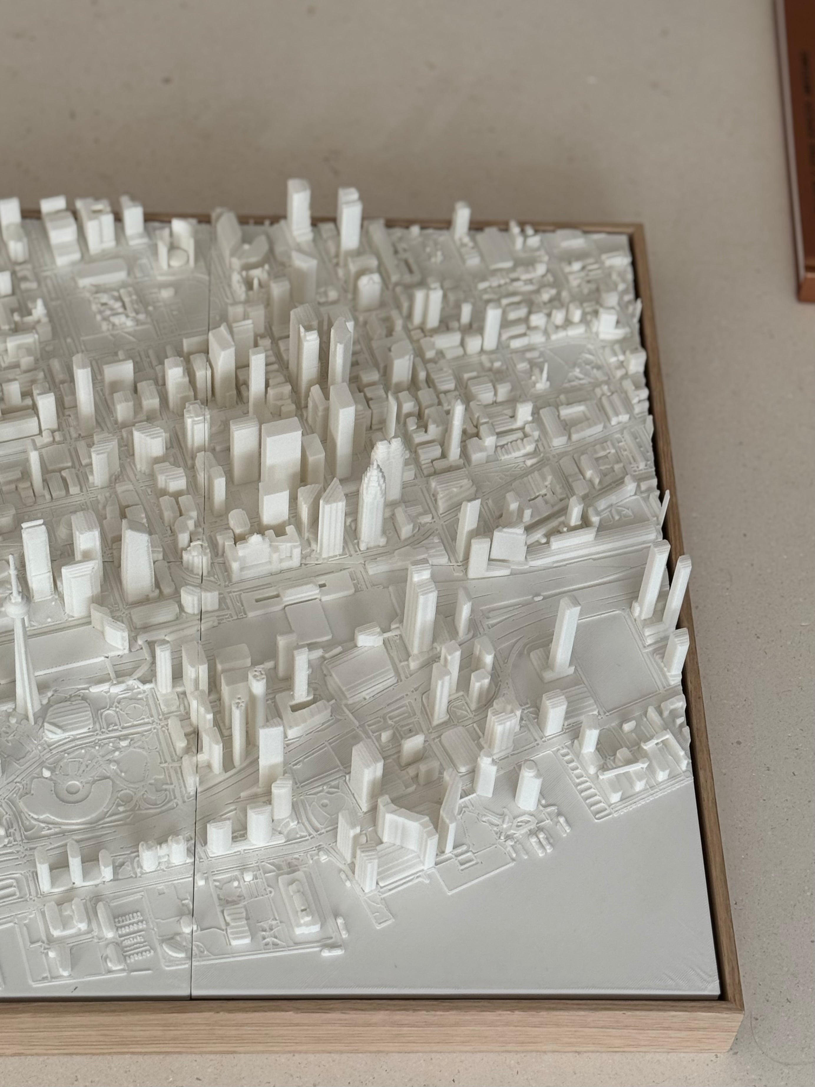 3D city map wall art featuring detailed white architectural buildings and city blocks