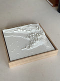 Framed 3D city map wall art in white relief on a light surface, modern home decor