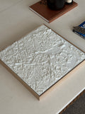 3D city map wall art in white on a coffee table, modern home decor accent piece