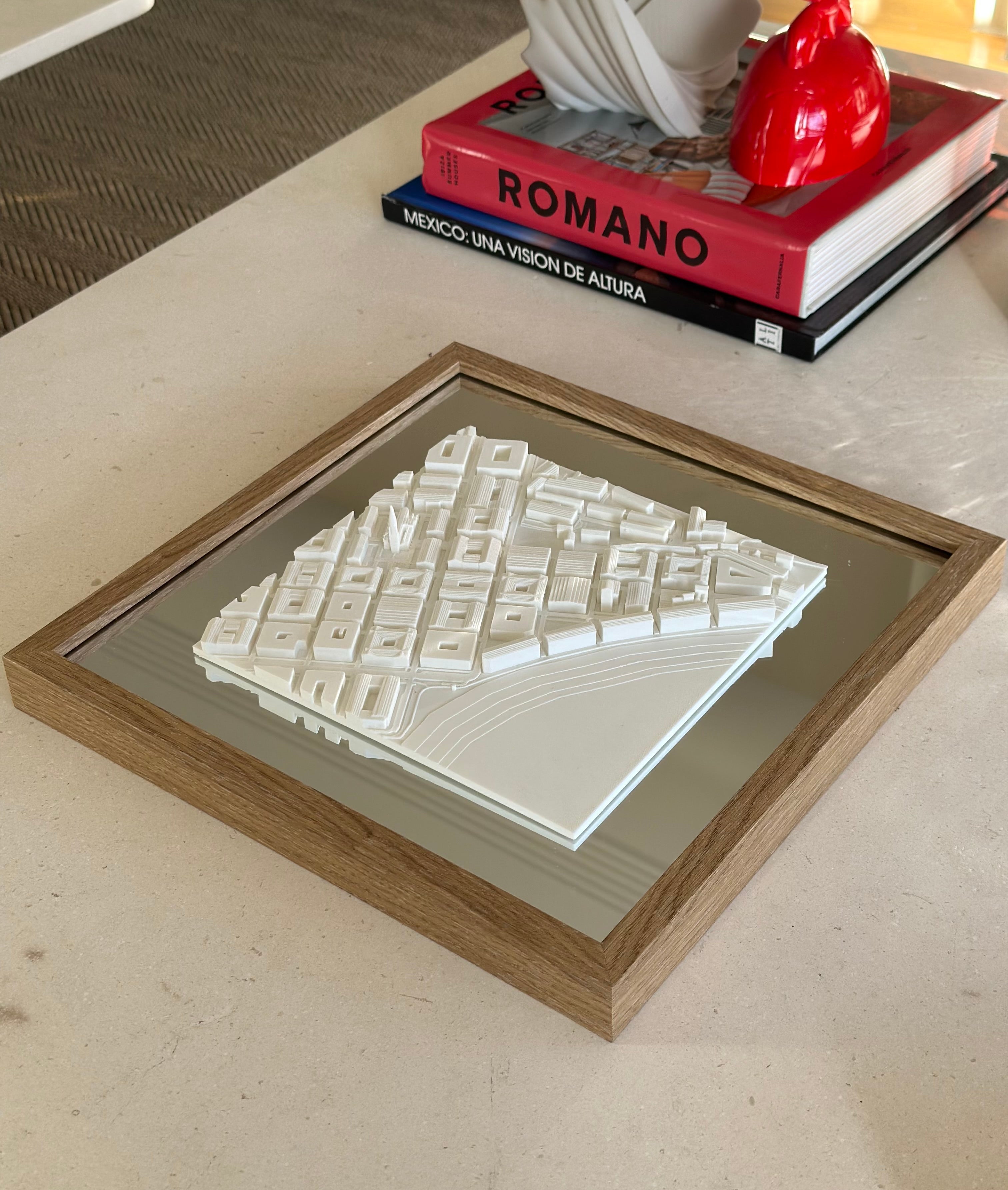 Framed 3D city map artwork on table, modern decor with architectural design