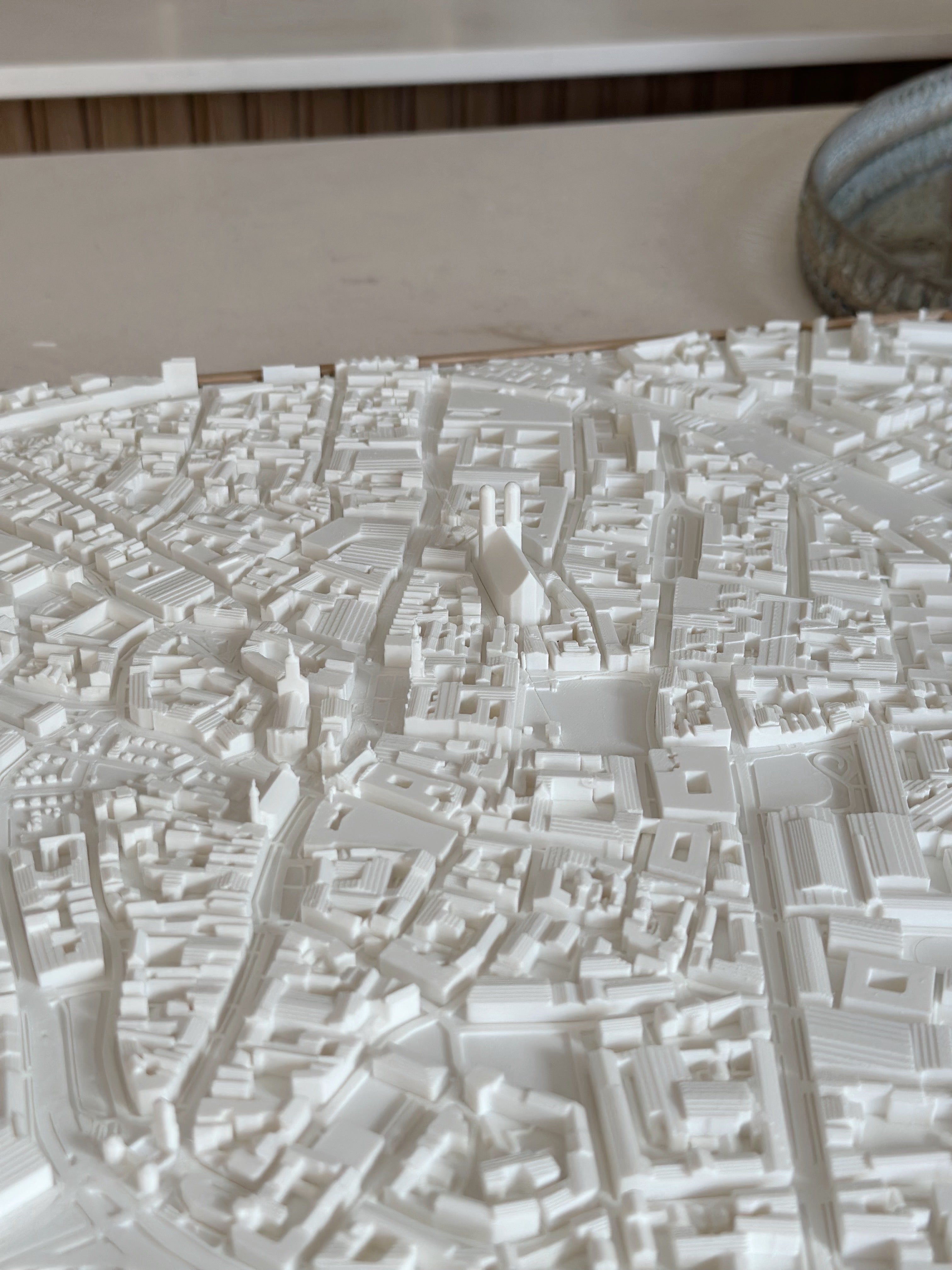 3D city map wall art with white buildings and detailed urban landscape model