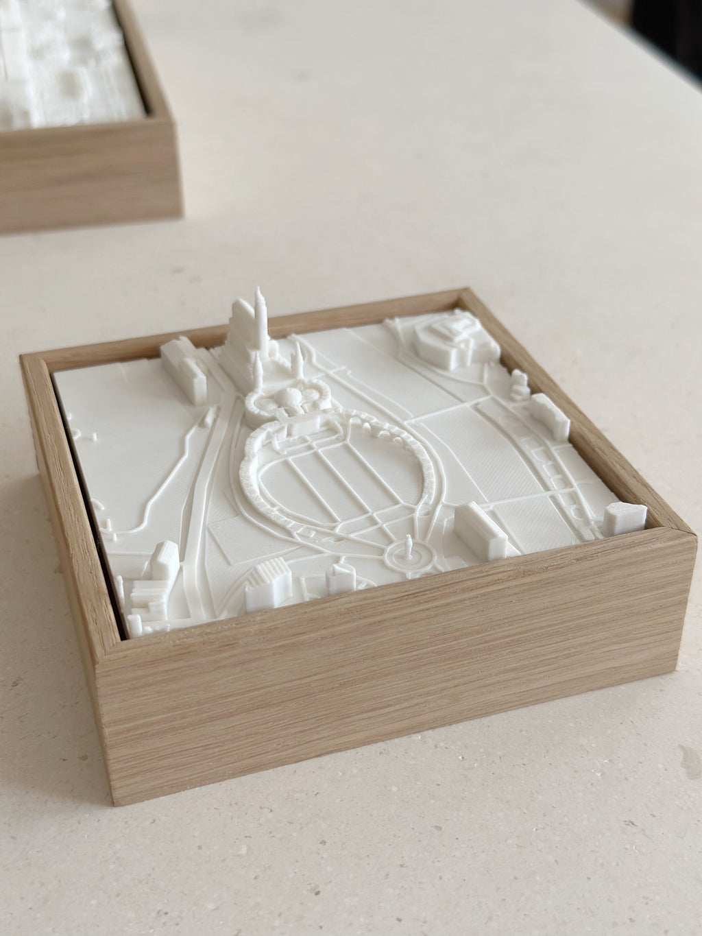 3D city map wall art in a wooden frame, minimalist home decor piece on a light surface