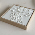 Framed 3D city map wall art with white topography and wood frame on light surface
