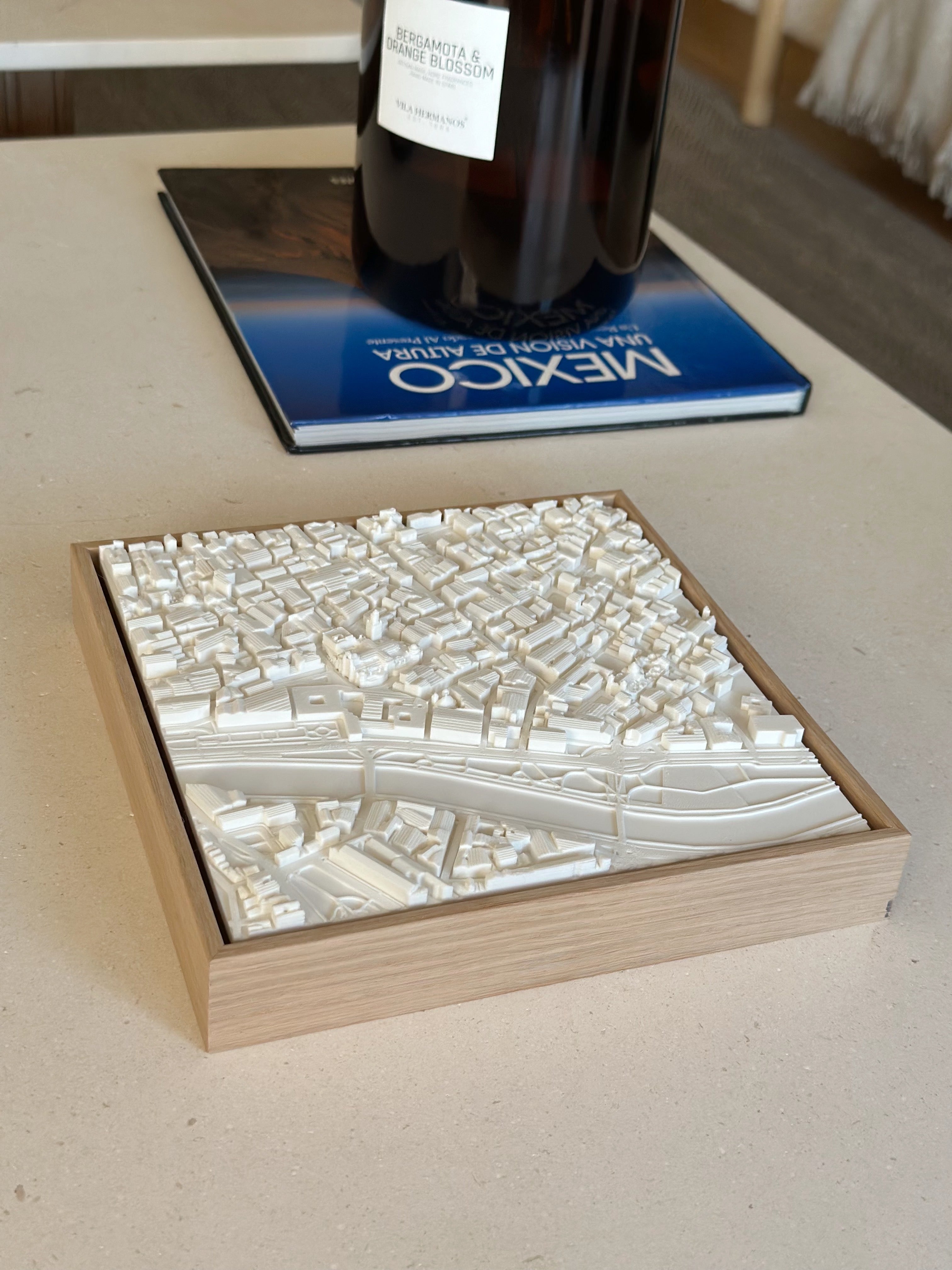 3D city map wall art in a wooden frame on a table, modern home decor for travelers