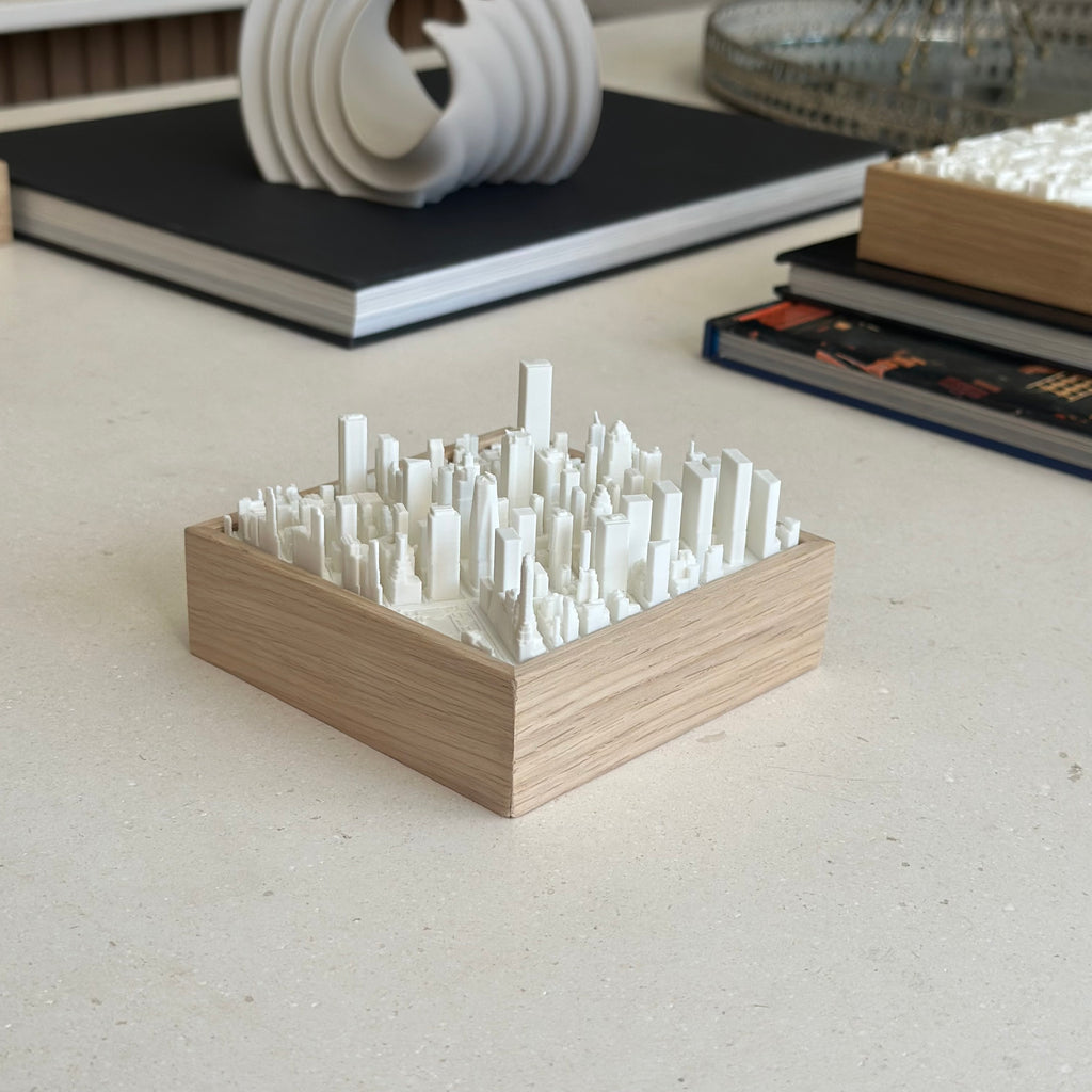 3D city map sculpture in wood frame, modern decor on a light tabletop