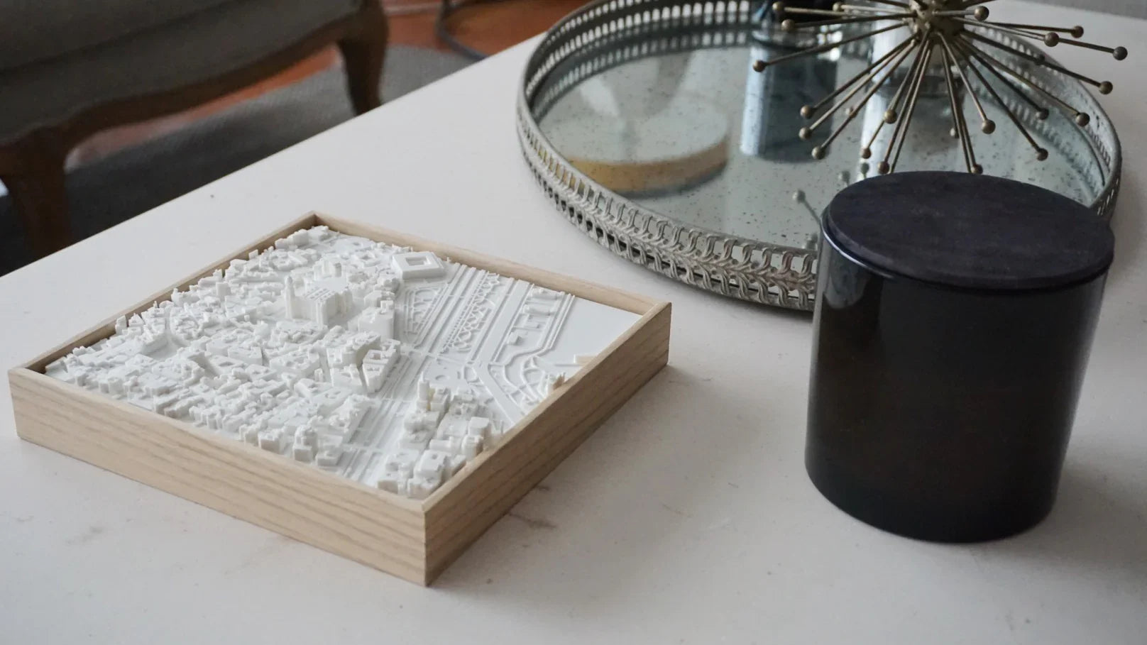 3D city map art in wooden frame displayed on a modern coffee table with decor