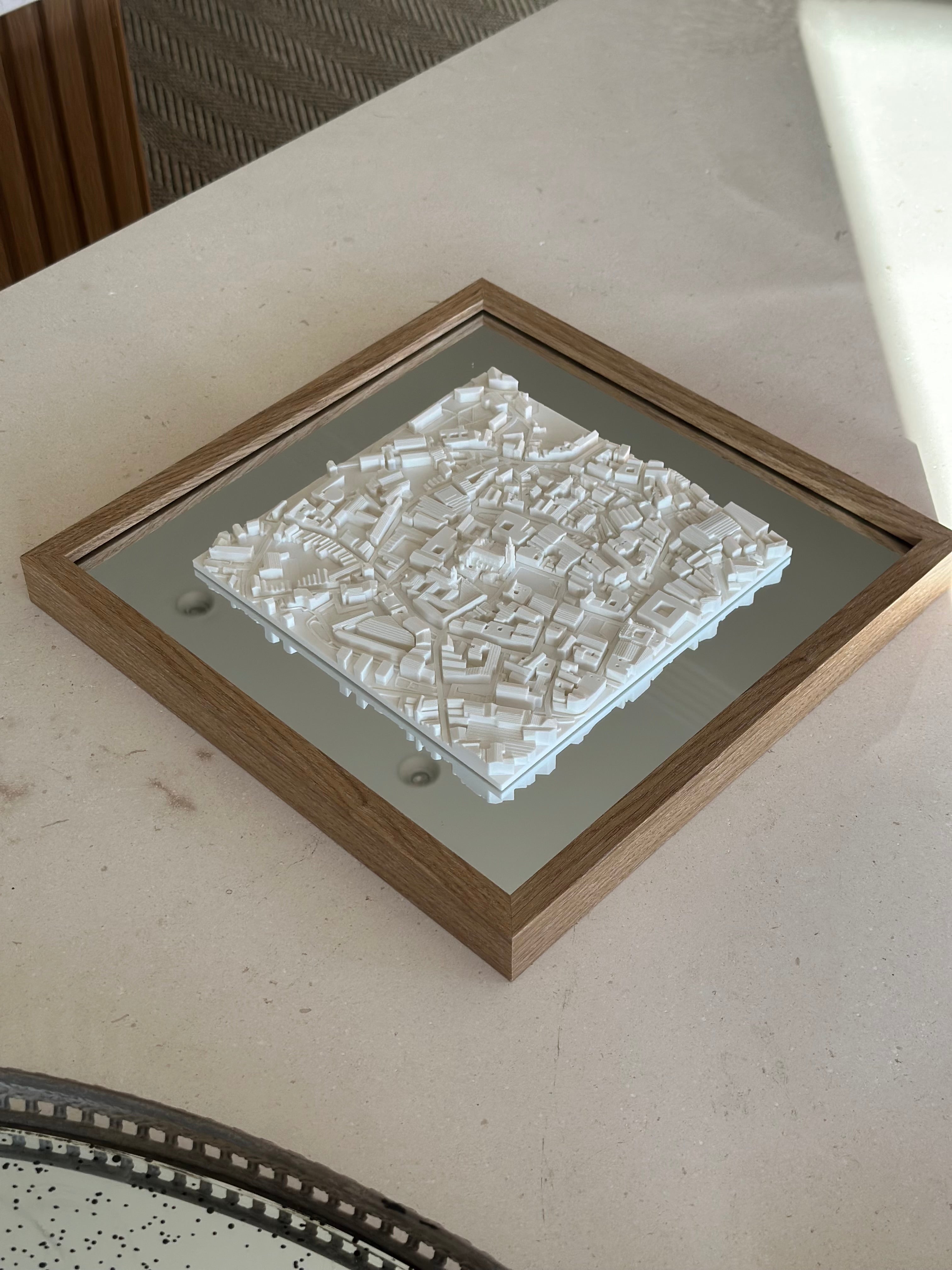 3D city map wall art in wooden frame on a minimalist table, modern home decor