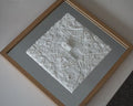 Framed 3D city map art piece with detailed white urban buildings and streets
