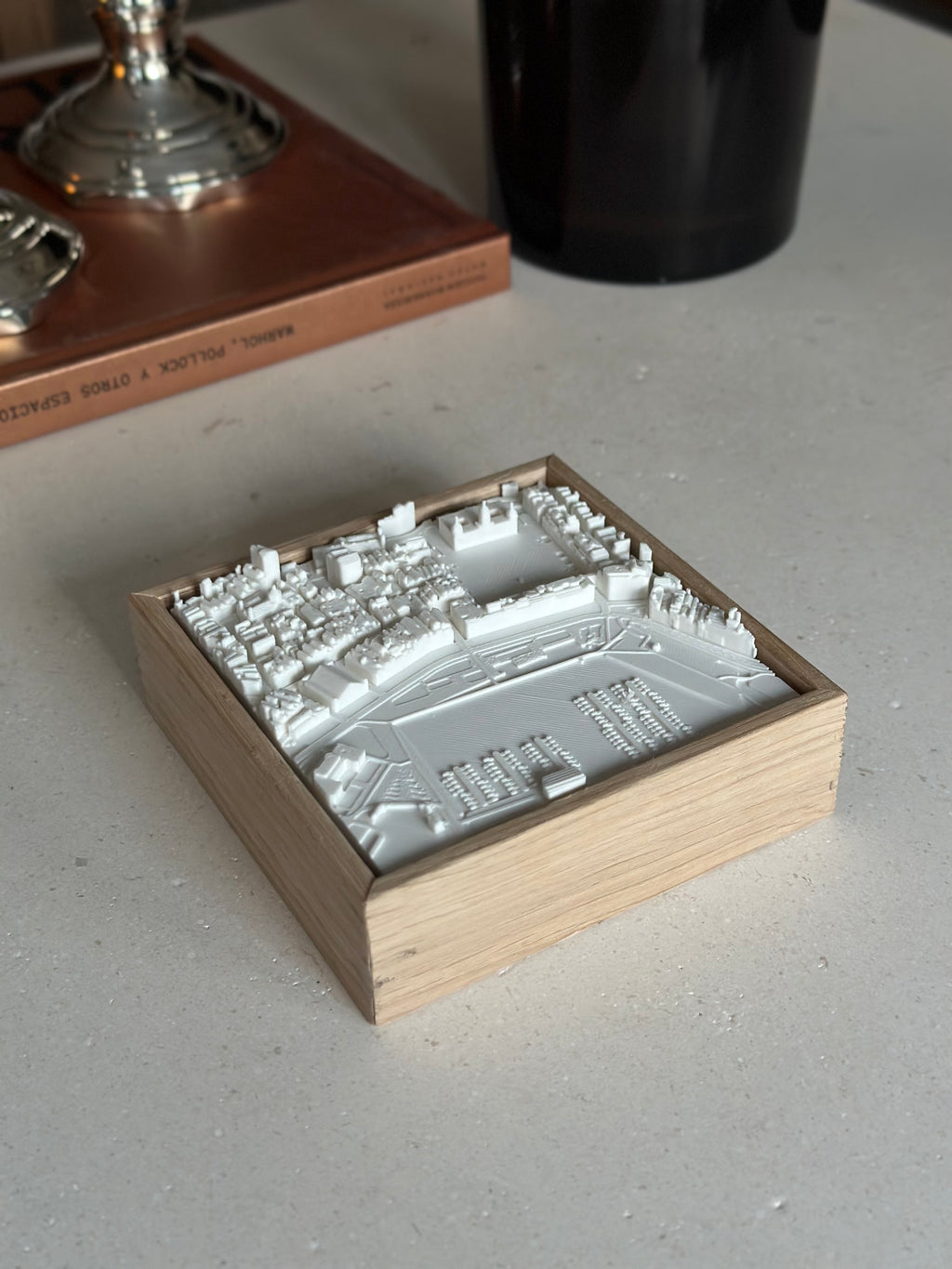 3D city map wall art in a wooden frame on a modern tabletop, cityscape decor piece