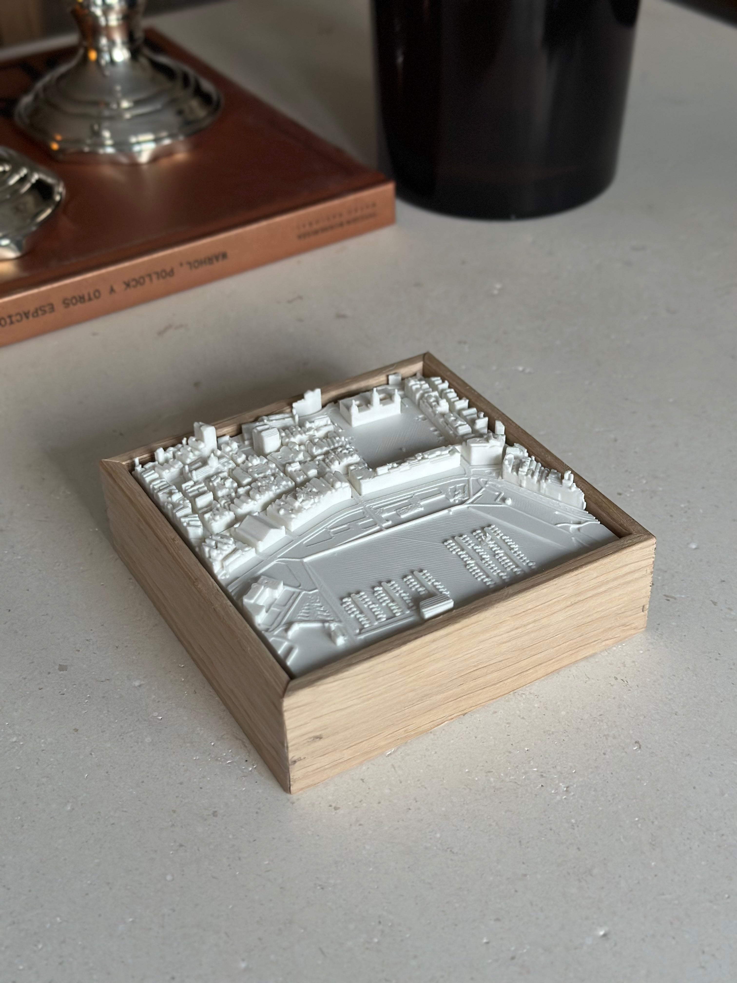 3D city map wall art in a wooden frame on a modern tabletop, cityscape decor piece