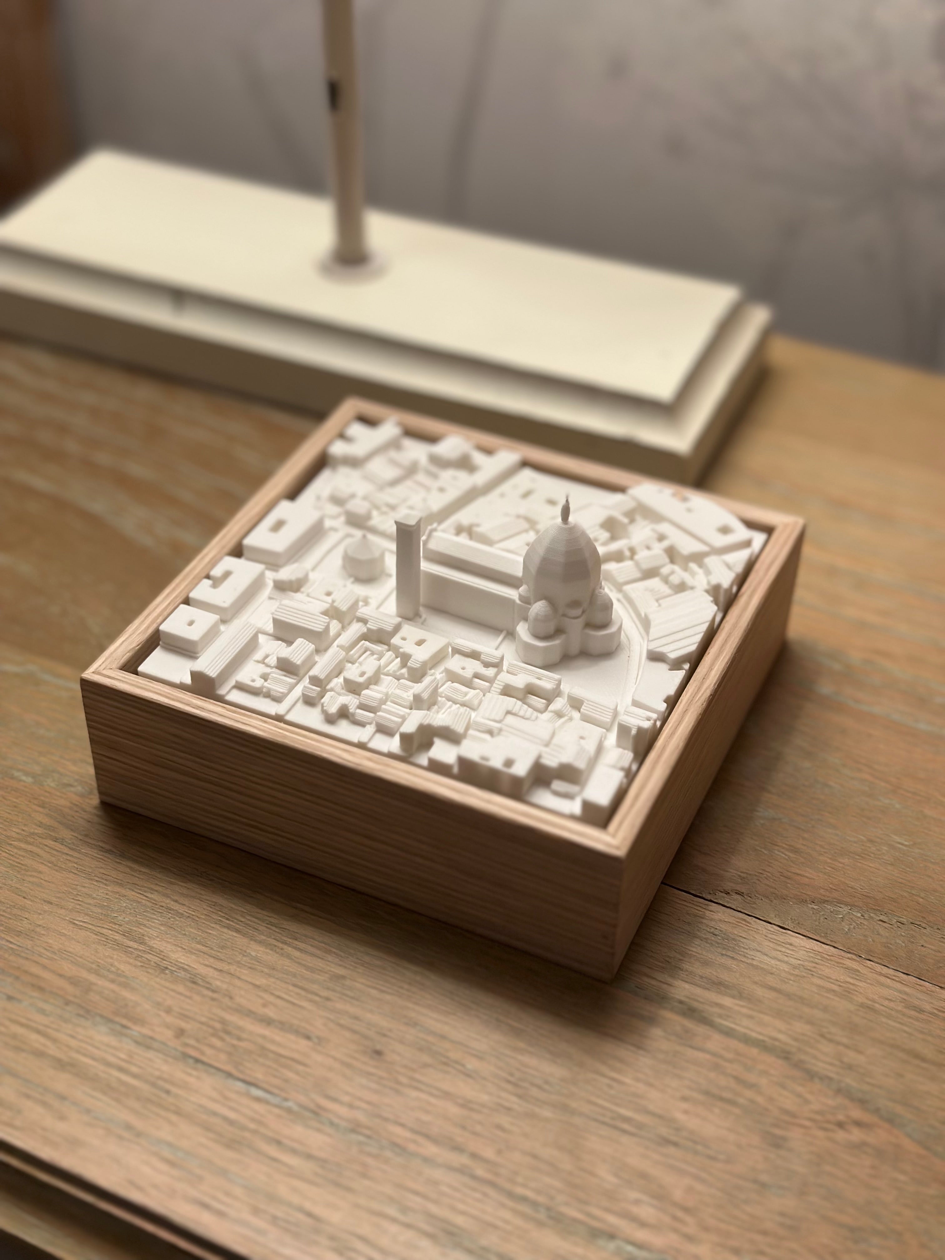 3D city map artwork in a wooden frame on a wooden desk, modern home decor