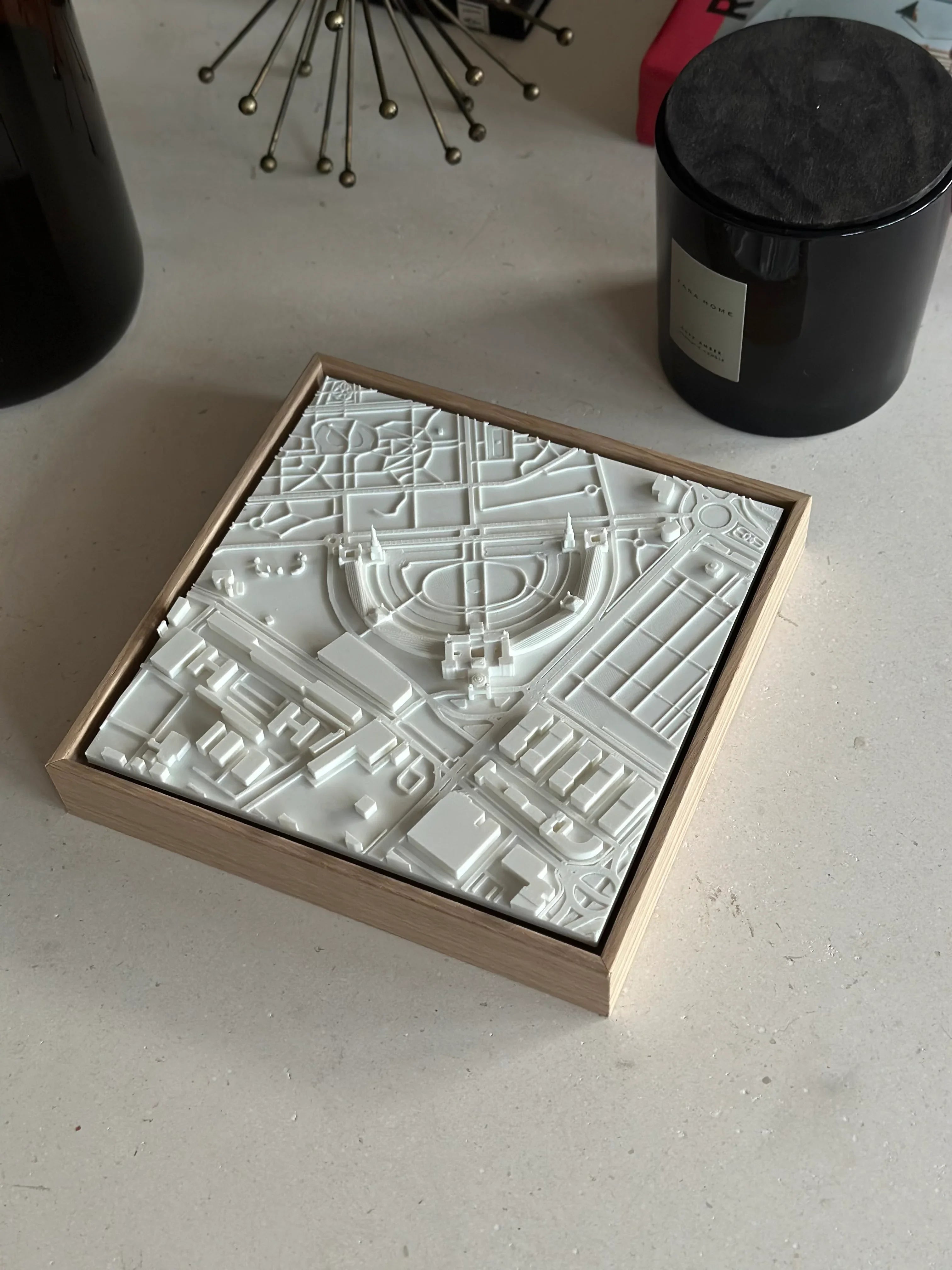 3D city map wall art in a wooden frame on a modern tabletop, decorative home accessory