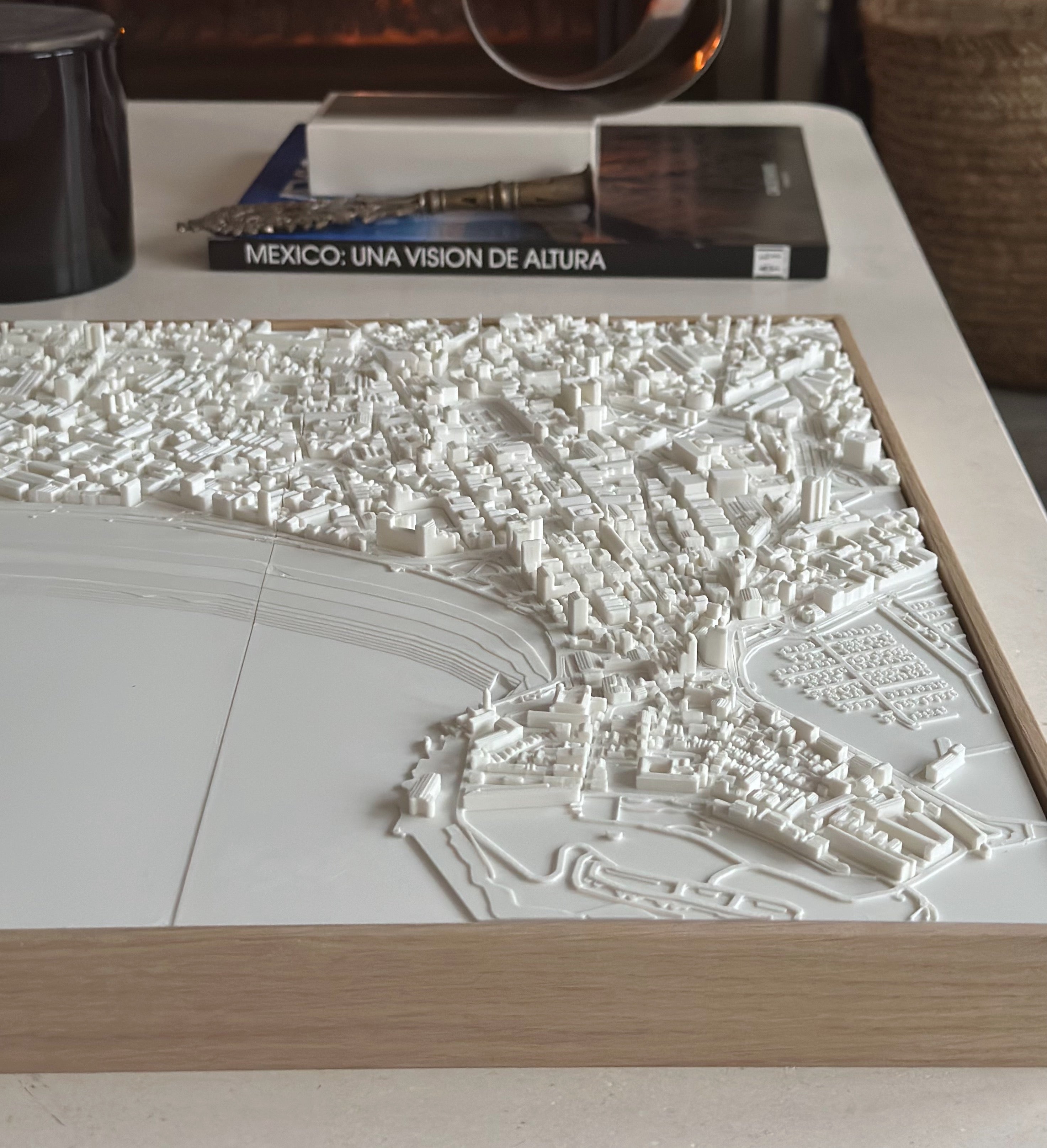 3D city map wall art in white with detailed buildings on a wooden frame, modern decor