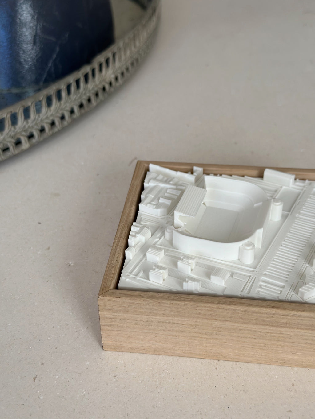 3D city map wall art in wooden frame on beige surface, modern home decor