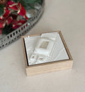 3D city map wall art in wooden frame on a table, with holiday decor in background