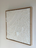 Framed white 3D city map wall art with detailed urban buildings and streets