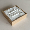 3D city map wall art in a wooden frame with raised white building models