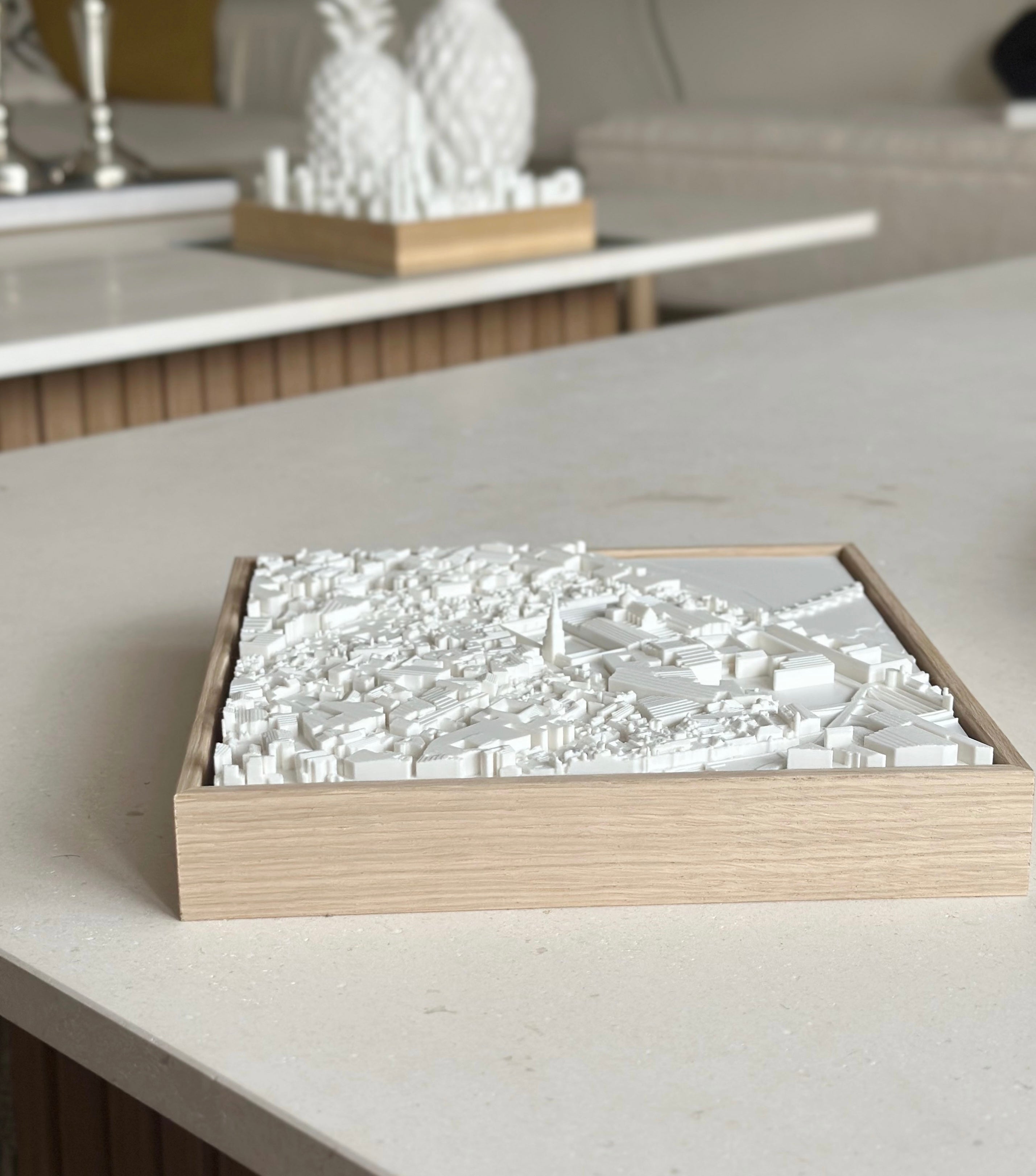 3D city map wall art in a wooden frame on a modern coffee table, minimalist decor