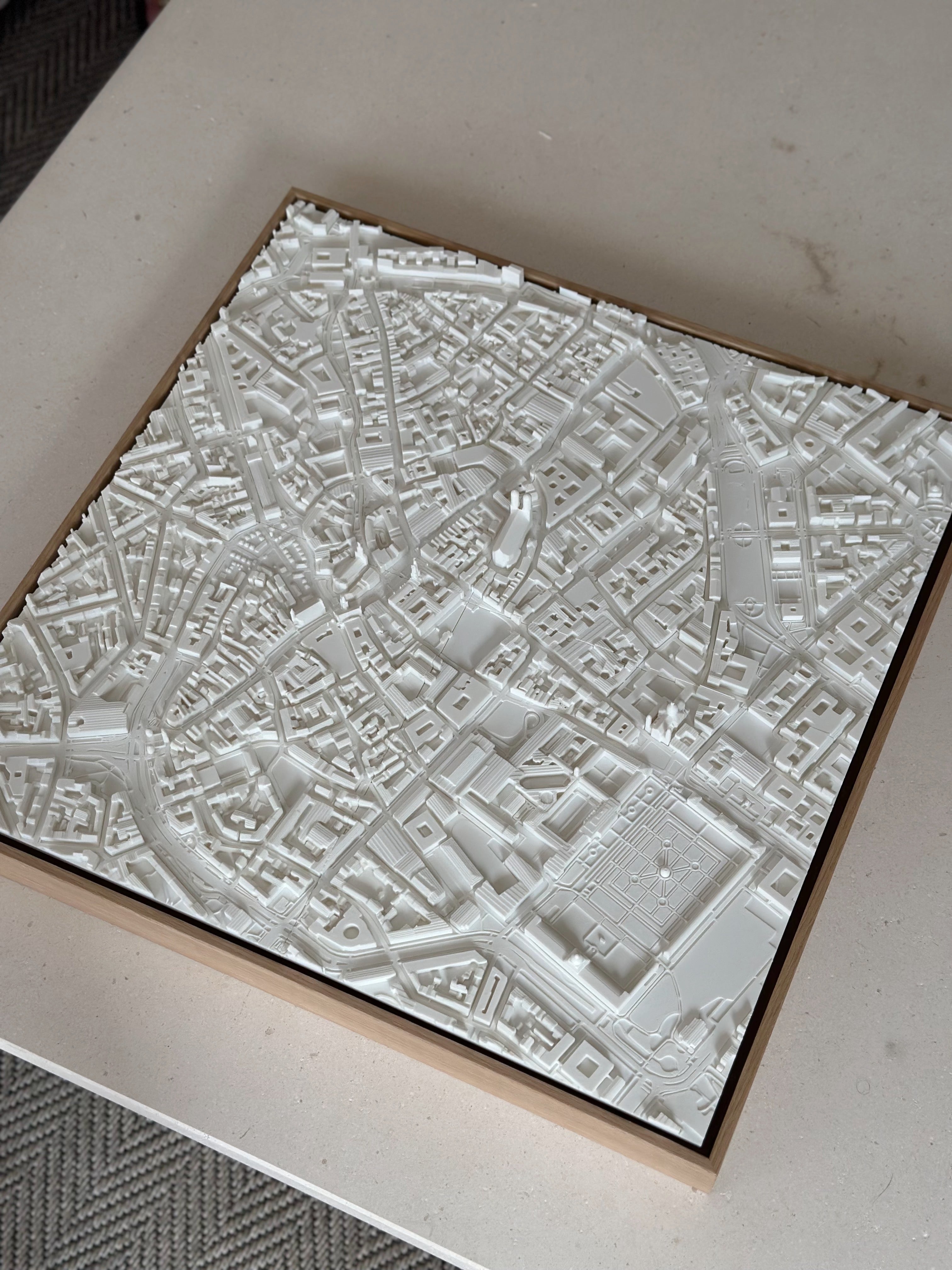 3D city map wall art in white, featuring detailed urban buildings and streets