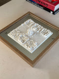 3D wall art map of a city with detailed buildings in a wood frame, modern home decor.