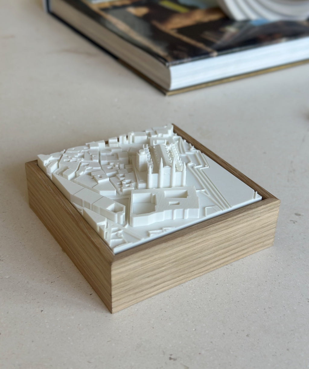 3D city map wall art in a wooden frame on a light table, modern home decor