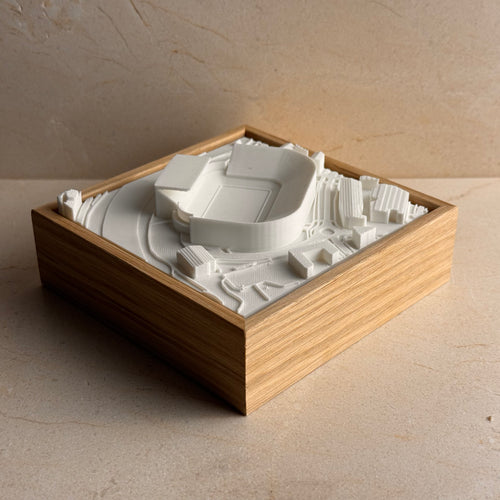3D city map art in wooden frame featuring a detailed miniature stadium model