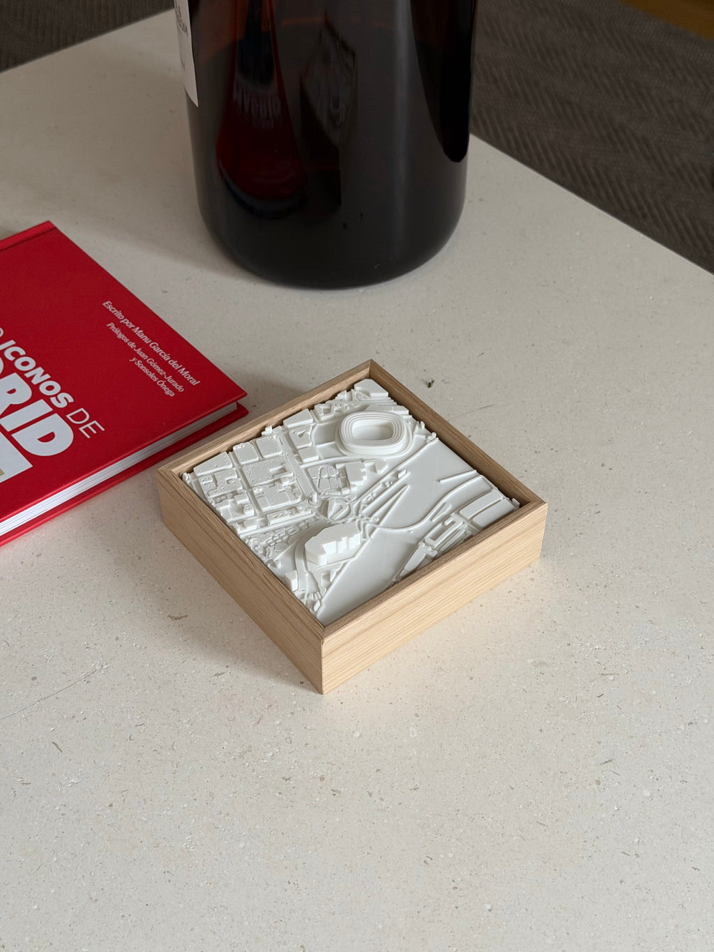 3D city map art in wooden frame on table, modern urban decor piece with white relief details