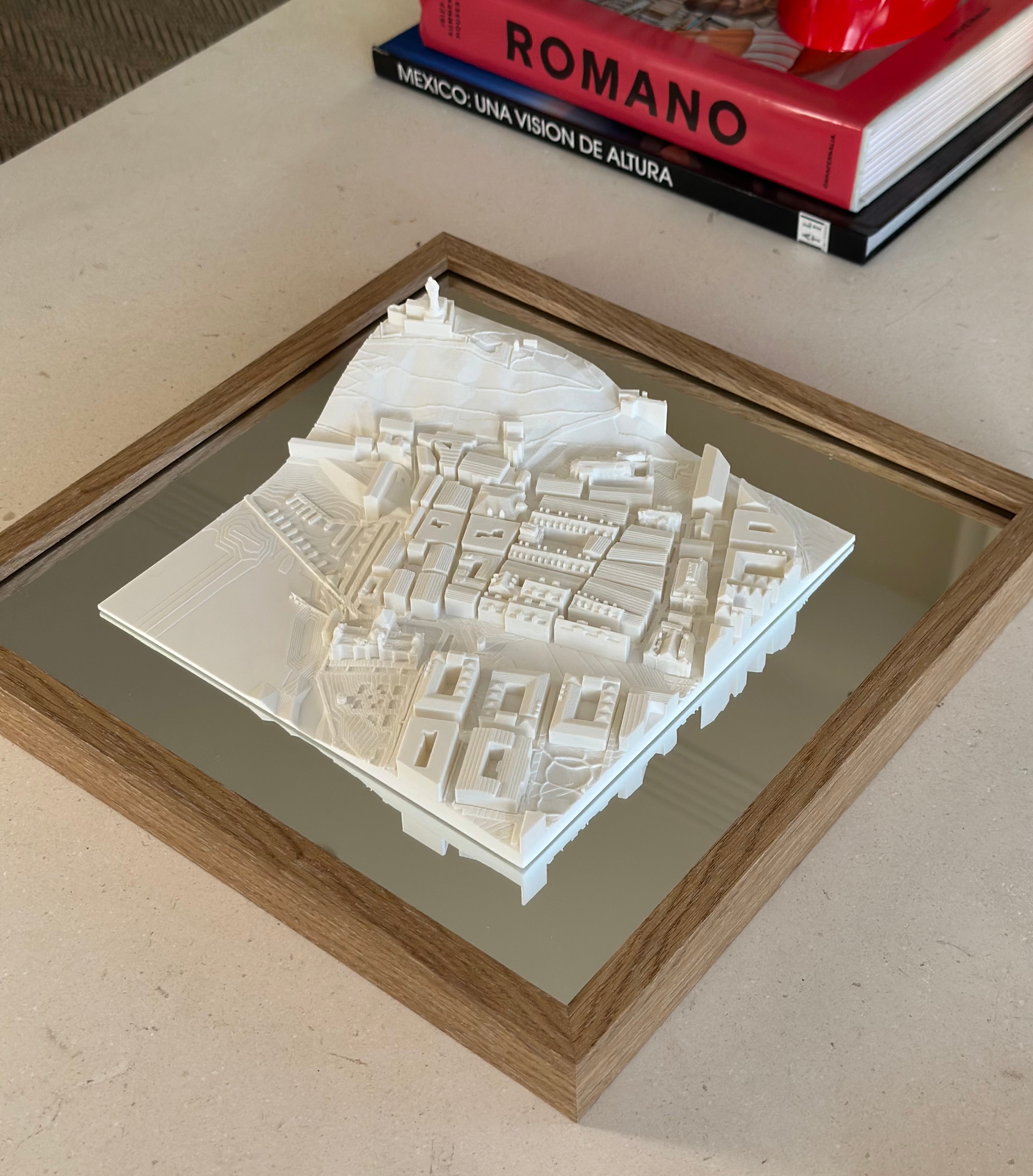 3D city map wall art in a wooden frame, modern decor on a coffee table with books