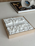 3D city map wall art in a wooden frame on a modern tabletop with decor