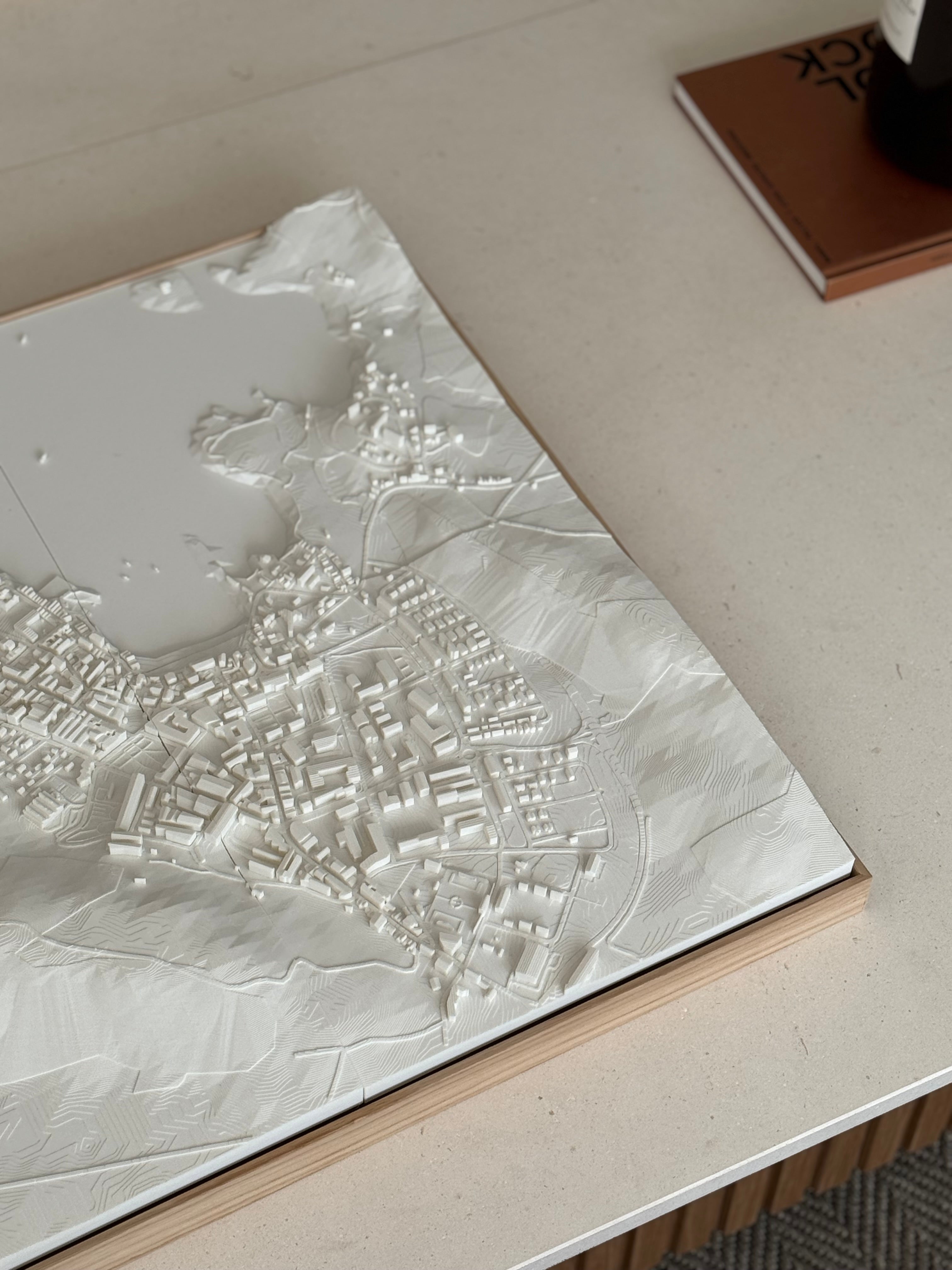 3D city map wall art with detailed white topography on a modern table