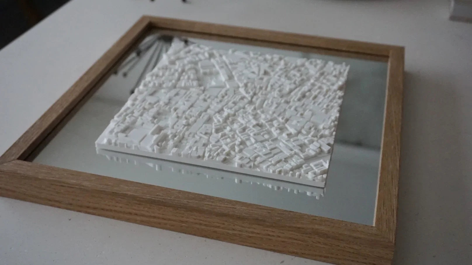 3D city map wall art with white buildings in a wooden frame, modern home decor