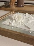 3D city map wall art with white buildings in a wooden frame, modern home decor