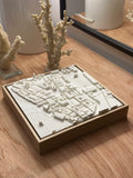 3D city map wall art in a wooden frame on a wooden table, modern decor style