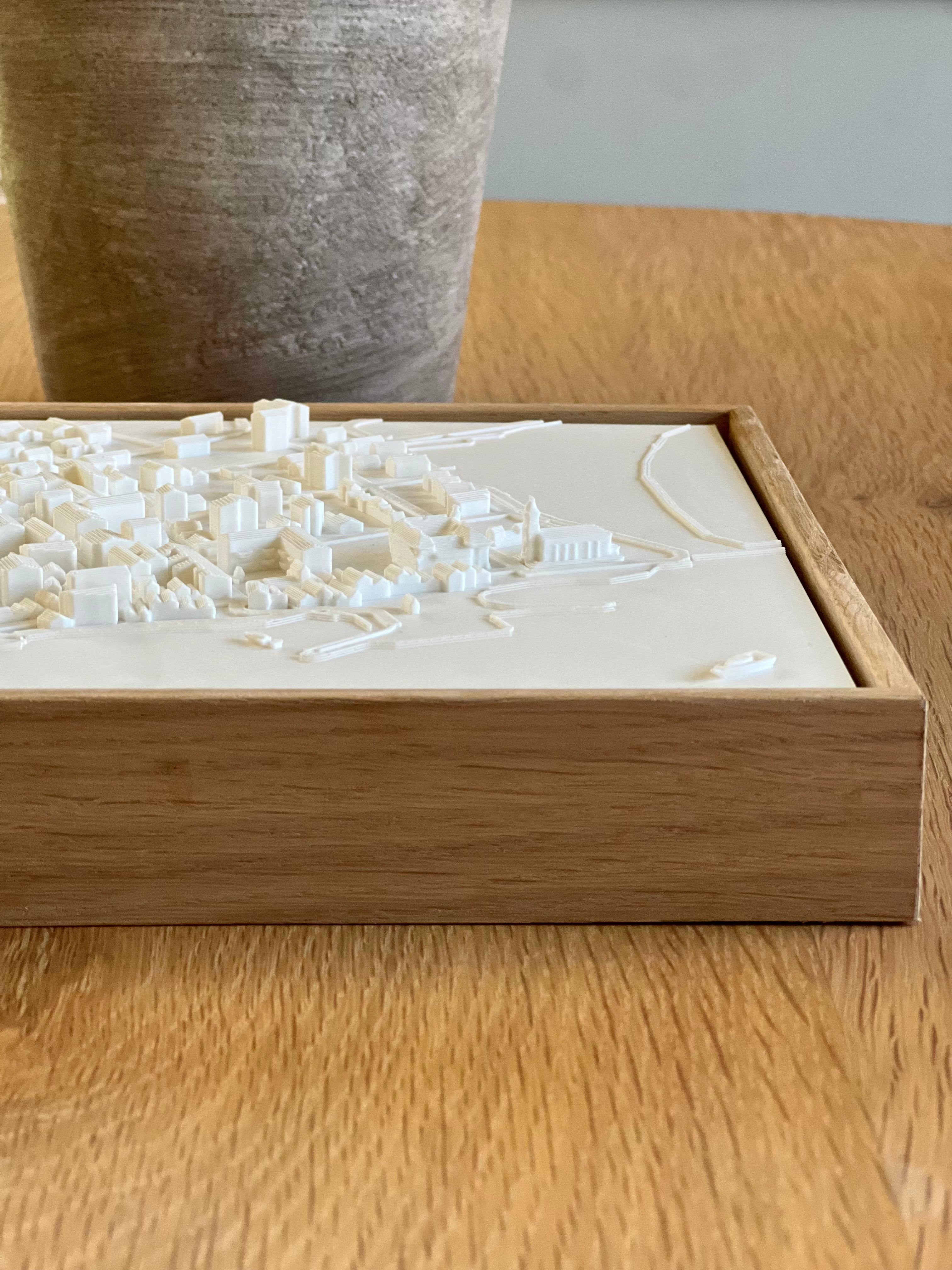 3D city map art in a wooden frame on a table, modern decor for travelers