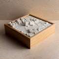3D city map wall art in a wooden frame, featuring detailed miniature cityscape model.