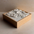 3D city map art in white with wooden frame, detailed urban model wall decor