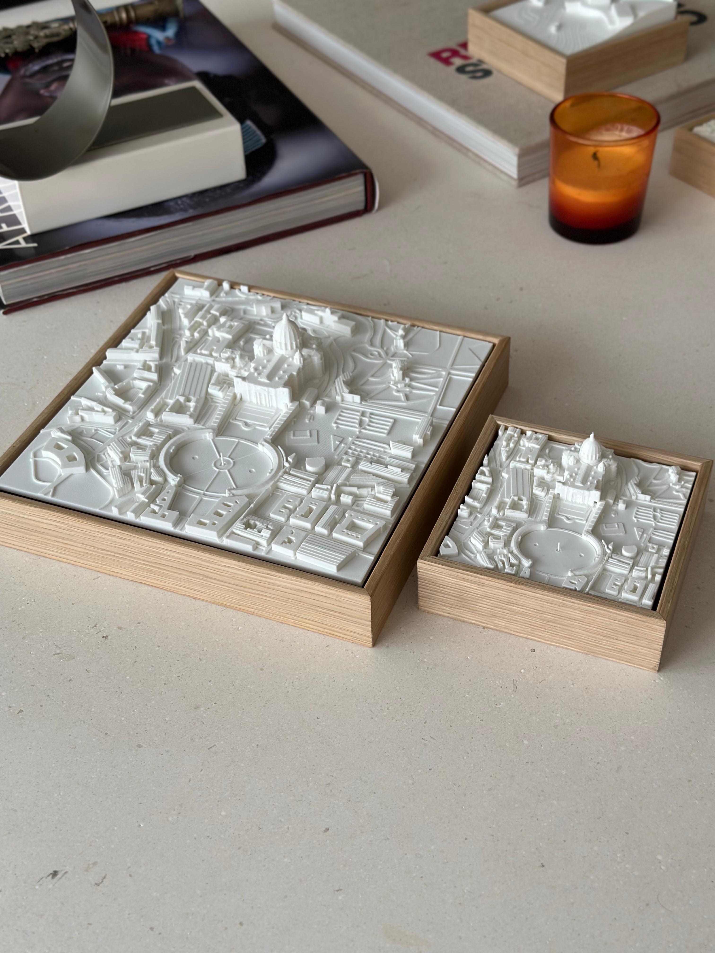 3D city map wall art in white with wooden frames, modern decor on tabletop with books and candle